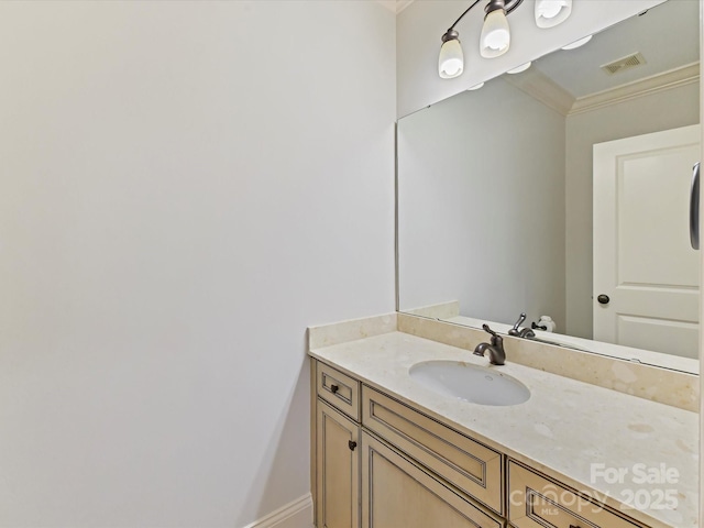 bathroom with baseboards, ornamental molding, vanity, and visible vents
