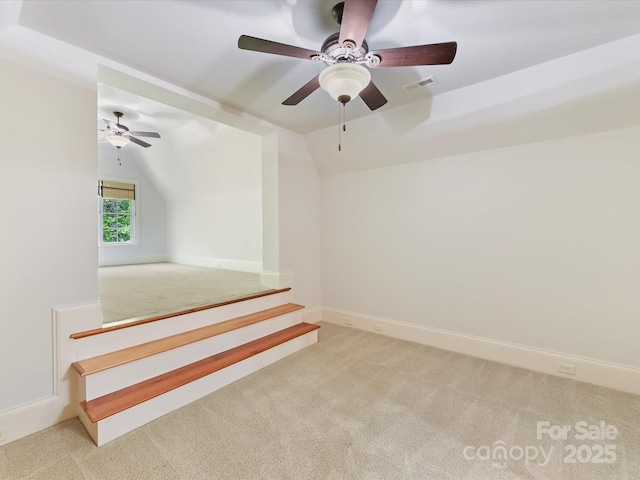 interior space with carpet floors, visible vents, and ceiling fan