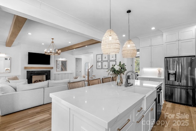 2165 Country Club Rd, Lincolnton, NC 28092 - kitchen featuring light wood finished floors, open floor plan, beam ceiling, and stainless steel fridge with ice dispenser
