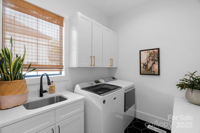 2165 Country Club Rd, Lincolnton, NC 28092 - clothes washing area featuring cabinet space, tile patterned floors, washing machine and clothes dryer, and a sink