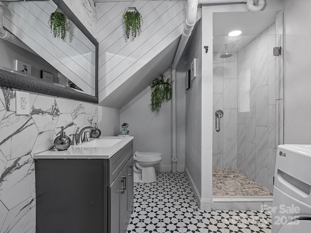 bathroom featuring a shower stall, tile patterned floors, toilet, vanity, and baseboards
