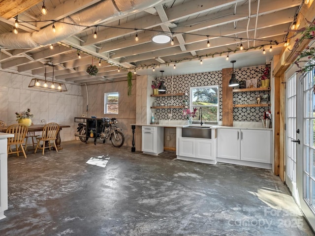 basement with a sink and concrete block wall