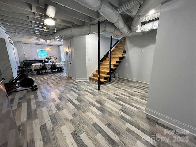 2701 N Sharon Amity Rd, Charlotte, NC 28205 - basement featuring baseboards, wood finished floors, and stairway