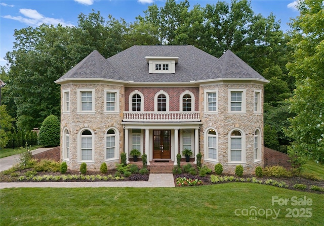colonial inspired home with stone siding, a front lawn, french doors, and a shingled roof