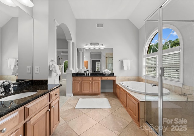 full bath with ornate columns, lofted ceiling, tile patterned flooring, a shower stall, and a bath