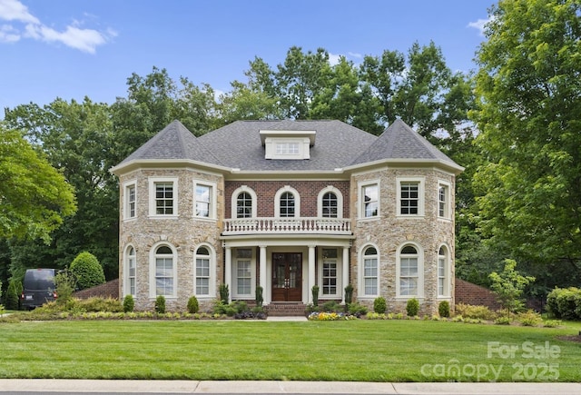 colonial house with stone siding and a front yard