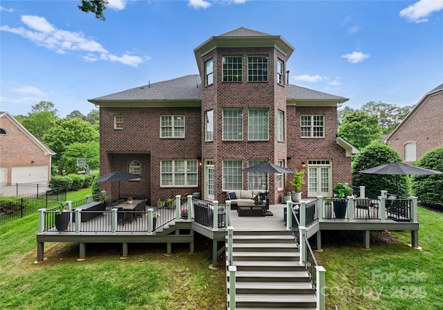 back of property featuring an outdoor living space, brick siding, a wooden deck, and roof with shingles