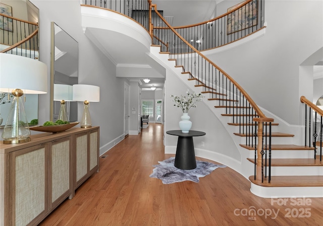 7005 Camrose Crossing Ln, Matthews, NC 28104 - entrance foyer with a towering ceiling, wood finished floors, stairs, baseboards, and crown molding