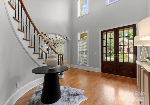 7005 Camrose Crossing Ln, Matthews, NC 28104 - entryway featuring french doors, plenty of natural light, wood finished floors, and a towering ceiling