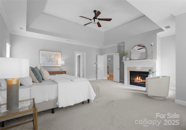 7005 Camrose Crossing Ln, Matthews, NC 28104 - carpeted bedroom featuring a fireplace, a raised ceiling, baseboards, crown molding, and ceiling fan