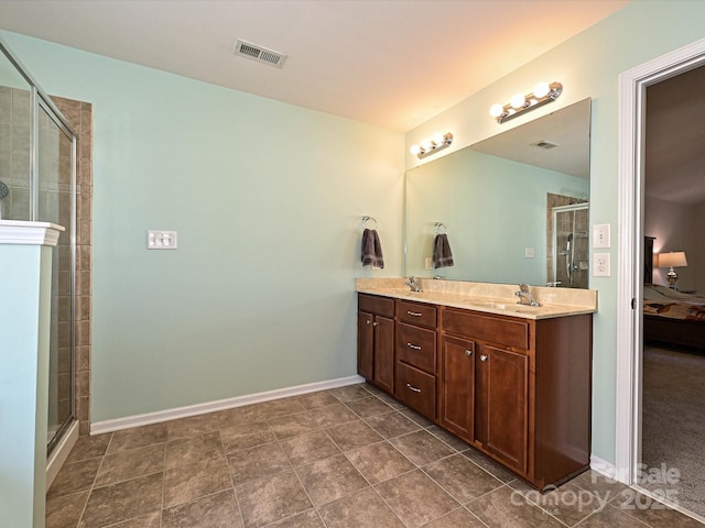 ensuite bathroom featuring visible vents, a sink, ensuite bathroom, and a stall shower