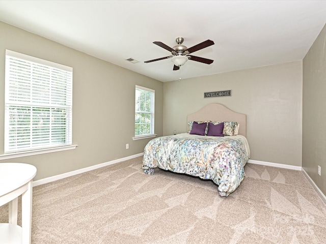 bedroom featuring baseboards, carpet, a ceiling fan, and visible vents