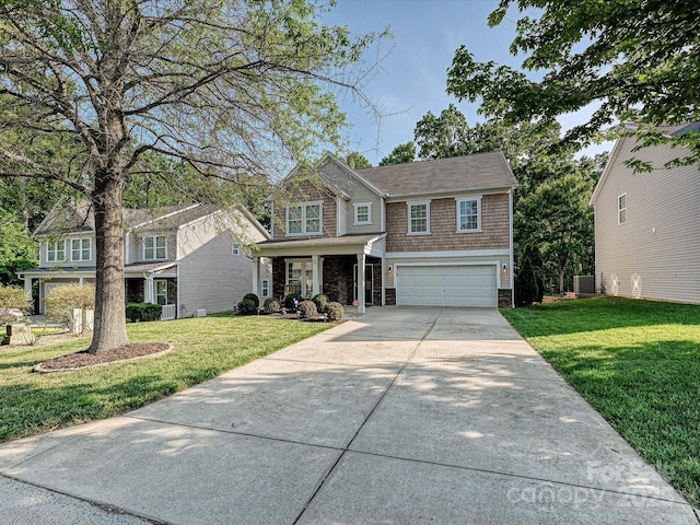 view of front of property featuring driveway, a front yard, a garage, central air condition unit, and stone siding