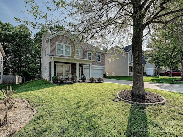 view of front facade featuring a garage, fence, driveway, and a front yard