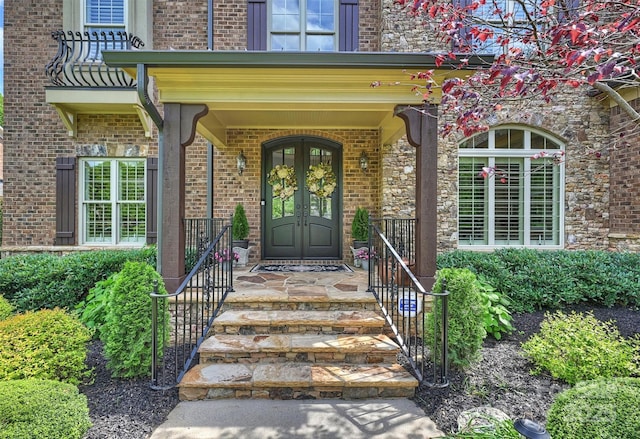 property entrance with brick siding and a porch