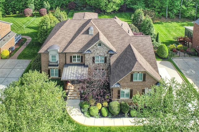 view of front of home featuring a shingled roof and brick siding