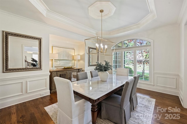 2001 Arundale Ln, Matthews, NC 28104 - dining area with a tray ceiling, a decorative wall, a chandelier, and dark wood-style floors
