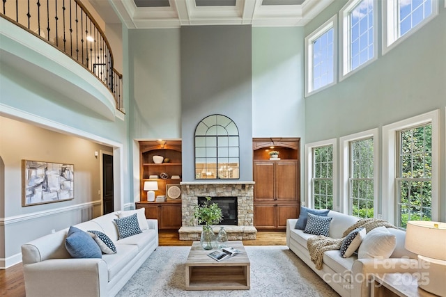 2001 Arundale Ln, Matthews, NC 28104 - living area featuring a stone fireplace, wood finished floors, baseboards, a high ceiling, and coffered ceiling