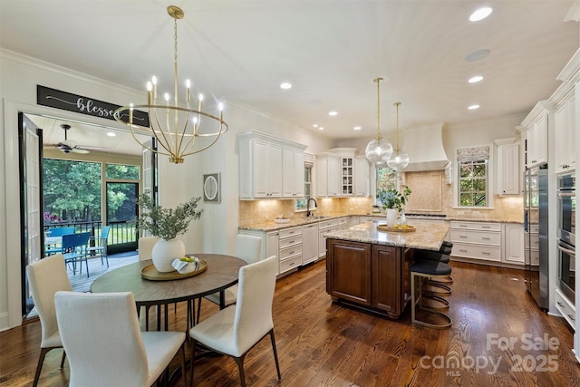 2001 Arundale Ln, Matthews, NC 28104 - kitchen with a center island, a sink, premium range hood, and ornamental molding