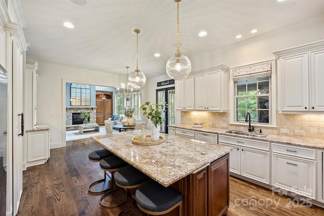 2001 Arundale Ln, Matthews, NC 28104 - kitchen featuring a sink, crown molding, white cabinetry, and open floor plan