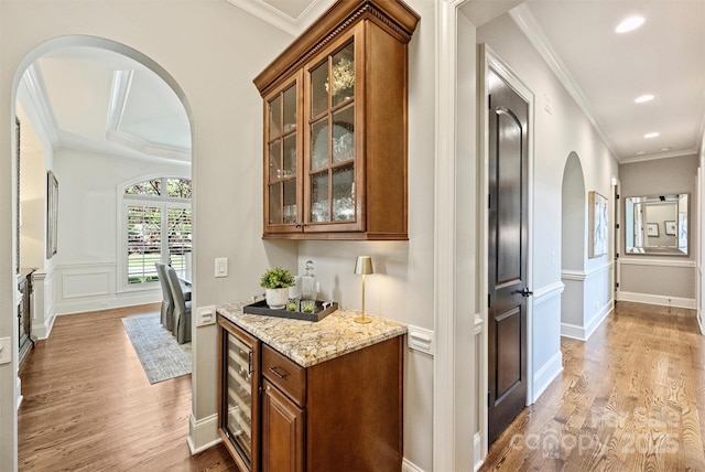 2001 Arundale Ln, Matthews, NC 28104 - bar with wine cooler, arched walkways, ornamental molding, and light wood finished floors