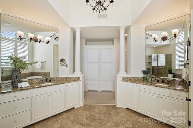2001 Arundale Ln, Matthews, NC 28104 - full bath with ornate columns, plenty of natural light, and a notable chandelier