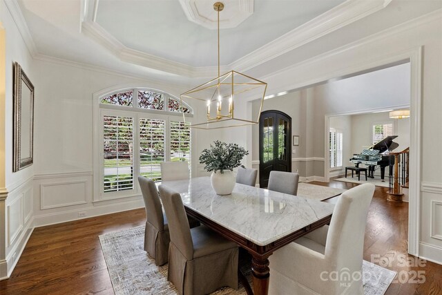 2001 Arundale Ln, Matthews, NC 28104 - dining room featuring crown molding, arched walkways, dark wood finished floors, a raised ceiling, and an inviting chandelier