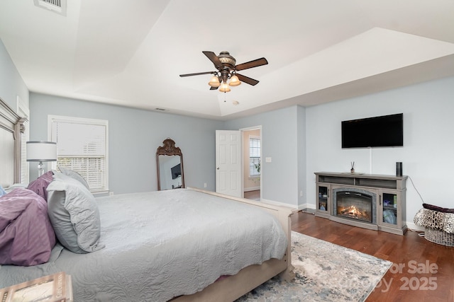 9904 Rocky Ford Club Rd, Charlotte, NC 28269 - bedroom featuring wood finished floors, ceiling fan, a glass covered fireplace, baseboards, and visible vents