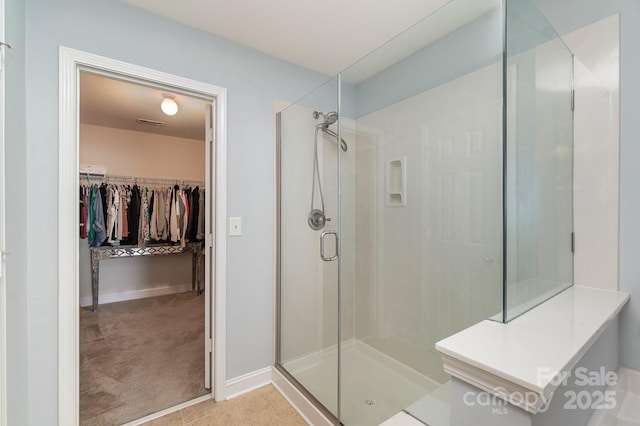 9904 Rocky Ford Club Rd, Charlotte, NC 28269 - full bathroom with a walk in closet, baseboards, and a shower stall