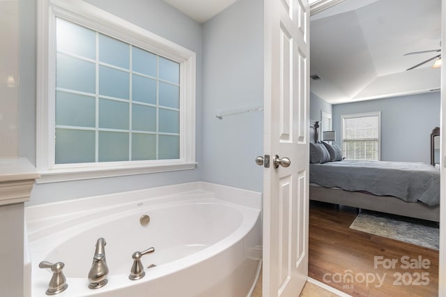 9904 Rocky Ford Club Rd, Charlotte, NC 28269 - bathroom with wood finished floors, ensuite bathroom, a ceiling fan, and a bath