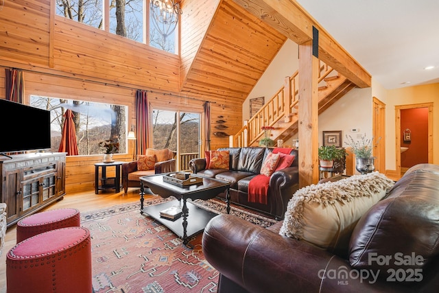 living area featuring recessed lighting, stairs, high vaulted ceiling, and wood finished floors
