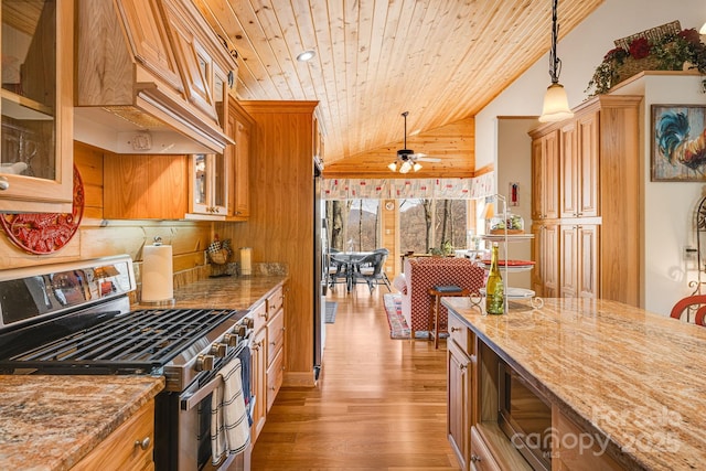 kitchen with light wood-style flooring, light stone counters, wood ceiling, stainless steel gas range oven, and custom range hood