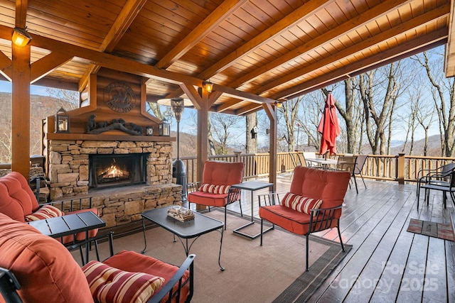 exterior space featuring outdoor dining space, a mountain view, and an outdoor living space with a fireplace
