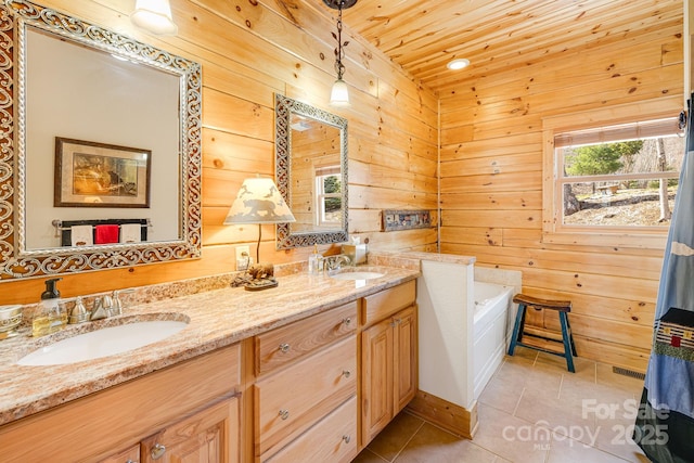 bathroom featuring wooden walls, tile patterned flooring, double vanity, and a sink