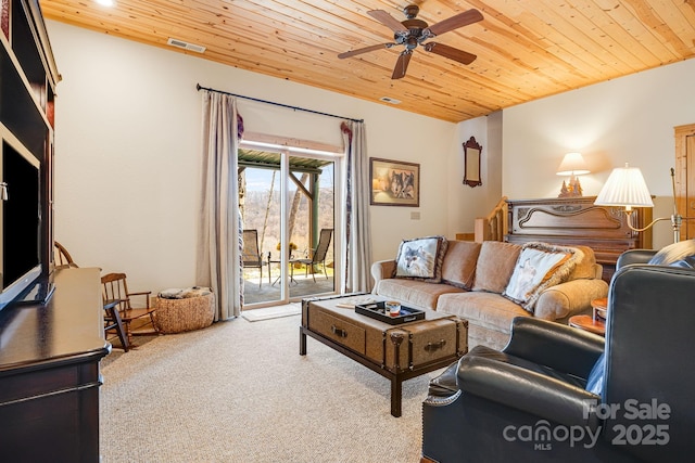 living room with visible vents, wooden ceiling, ceiling fan, and carpet