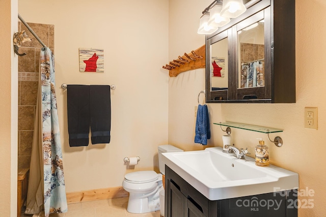 bathroom featuring toilet, a tile shower, tile patterned flooring, and vanity