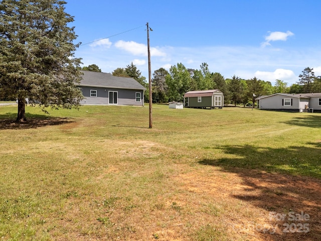view of yard with a storage shed and an outdoor structure