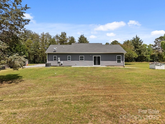 back of property with a lawn and cooling unit