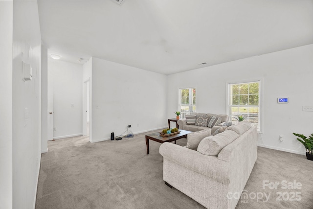 carpeted living area featuring baseboards and visible vents