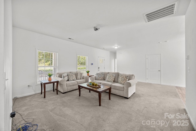 living room featuring baseboards, carpet flooring, and visible vents