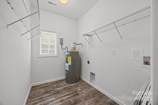 washroom with laundry area, hookup for a washing machine, wood finished floors, visible vents, and electric water heater