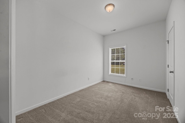 unfurnished room featuring carpet floors, baseboards, and visible vents