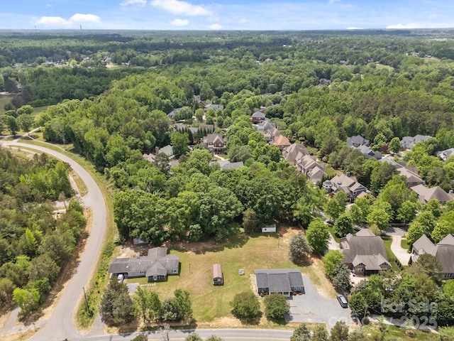 birds eye view of property with a residential view and a forest view