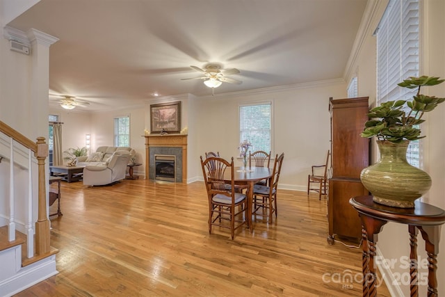 3 Kensington Ct, Granite Falls, NC 28630 - dining room featuring a fireplace, a ceiling fan, stairs, and light wood-style flooring