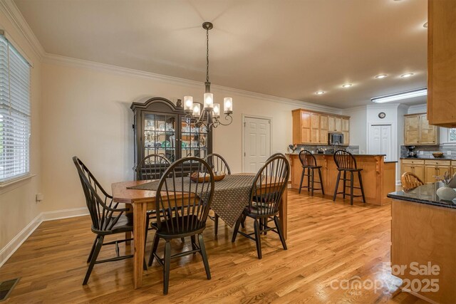 3 Kensington Ct, Granite Falls, NC 28630 - dining space with crown molding, baseboards, light wood-type flooring, and a notable chandelier