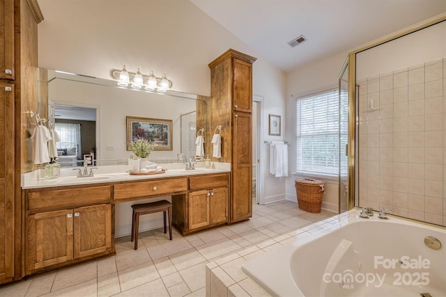 3 Kensington Ct, Granite Falls, NC 28630 - full bathroom with a garden tub, visible vents, vaulted ceiling, a sink, and tile patterned floors