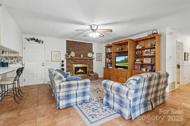 174 Sunny Knoll Ln, Boone, NC 28607 - living area featuring ceiling fan, light tile patterned floors, a brick fireplace, and crown molding