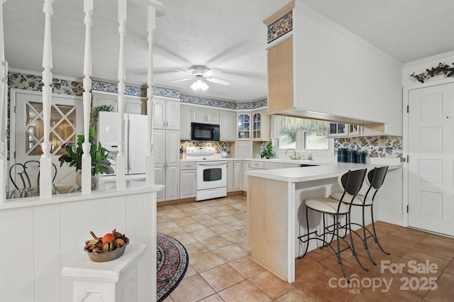 174 Sunny Knoll Ln, Boone, NC 28607 - kitchen featuring white appliances, a peninsula, a ceiling fan, tasteful backsplash, and crown molding