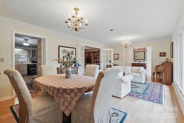 174 Sunny Knoll Ln, Boone, NC 28607 - dining room featuring a chandelier, light wood finished floors, and ornamental molding