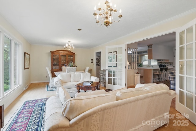 174 Sunny Knoll Ln, Boone, NC 28607 - living area featuring a chandelier, light wood-type flooring, and french doors